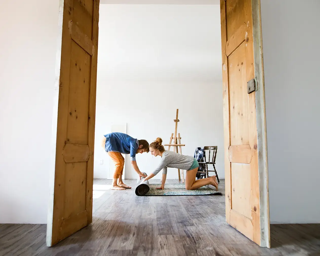 A photo of a young couple moving into their home after seeking pre-approval and securing a home loan.